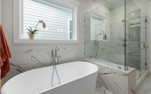 Bathtub and shower with marble-look tile walls