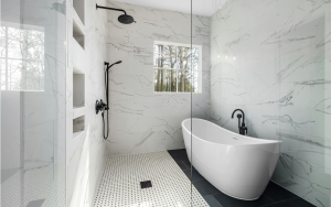 Freestanding tub with marble-look shower walls in modern bathroom