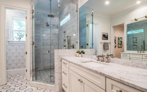 Marble bathroom countertop with glass shower enclosure