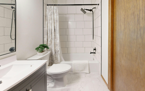 Small bathroom remodel with tub, tile walls, and vanity countertop