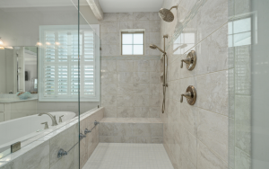 Walk-in shower with tile walls and glass enclosure